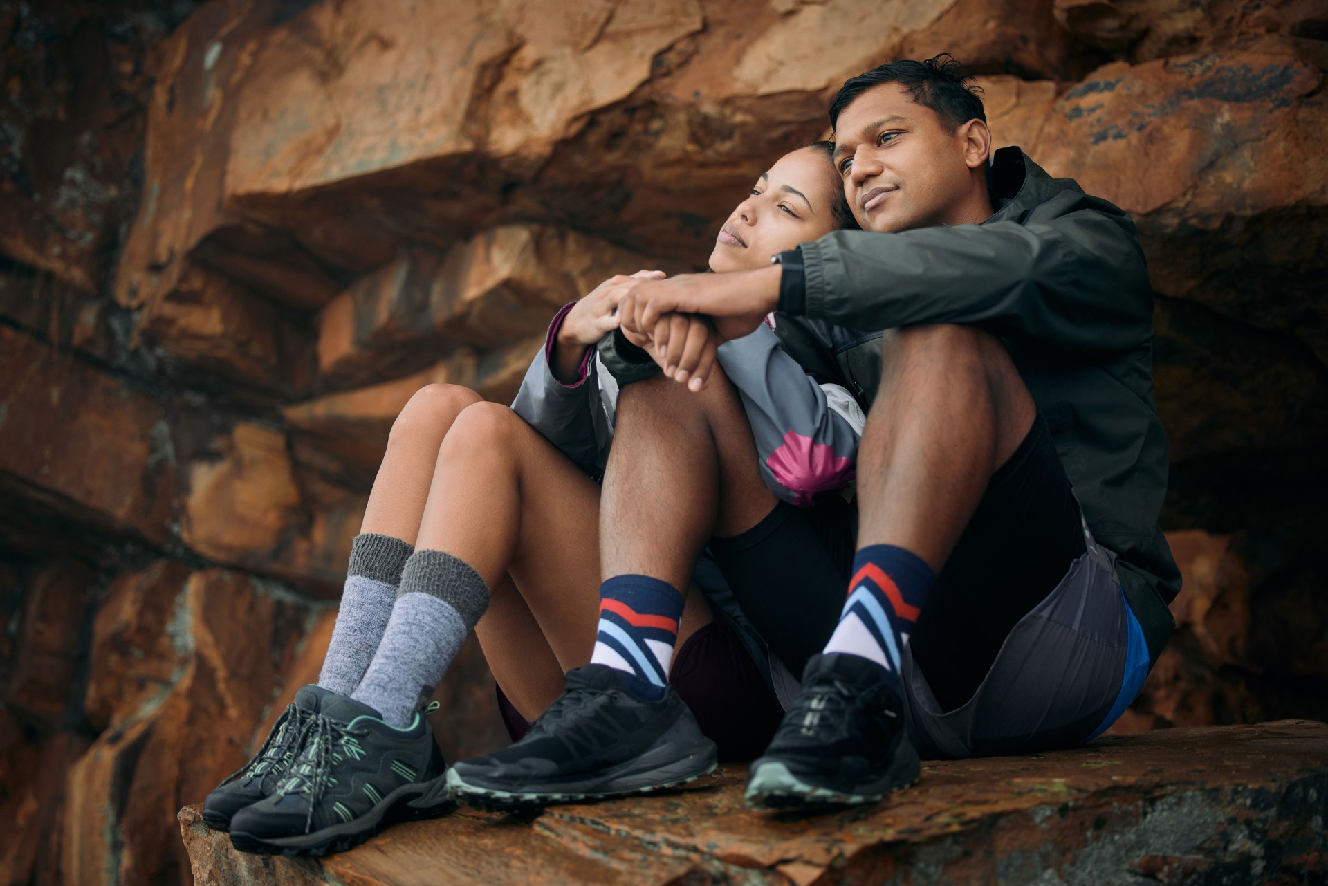 Shot of a young couple admiring the view while out hiking together